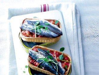 Boxes of sardines with fresh tomatoes