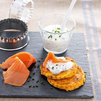 Small sweet potato blinis with herbs and almonds, smoked trout